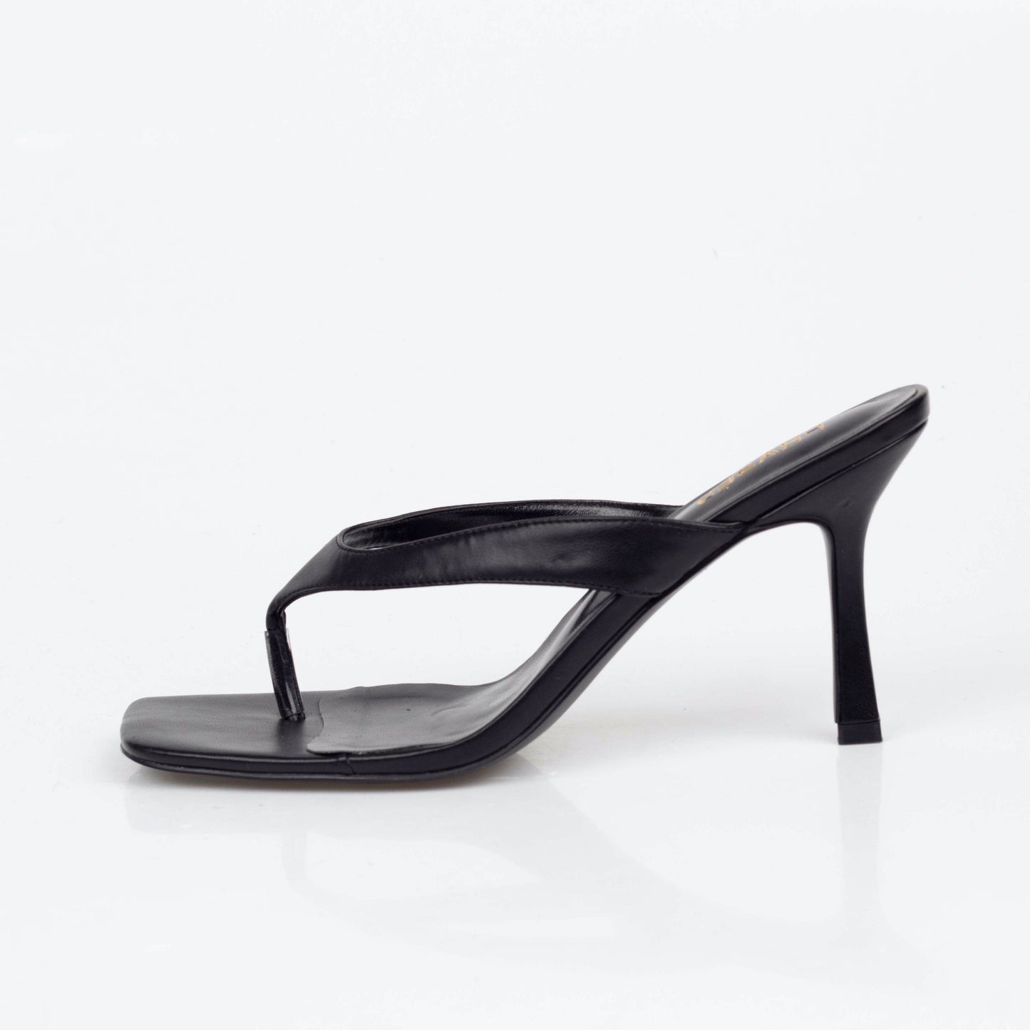Side view of black flip flop style heels